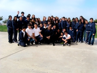 Board Member Oswell Melton with the students of Colegio Reina Isable